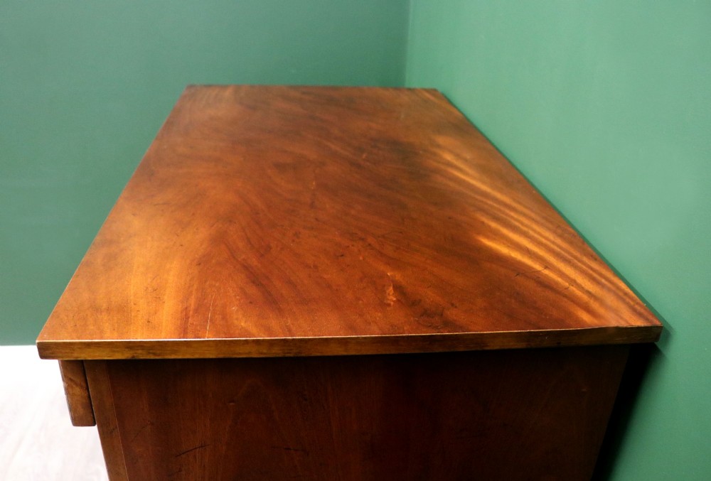 A small Victorian mahogany chest of drawers featuring decorative inlay along the frame, turned wooden knobs, and a shaped apron on curved feet. View VIII