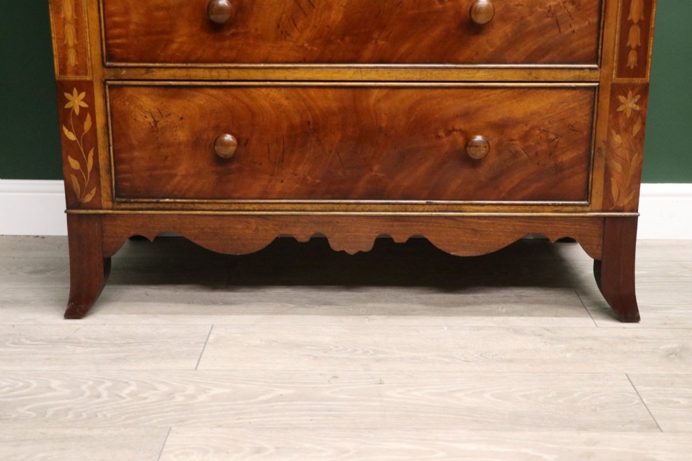 A small Victorian mahogany chest of drawers featuring decorative inlay along the frame, turned wooden knobs, and a shaped apron on curved feet. View XIV