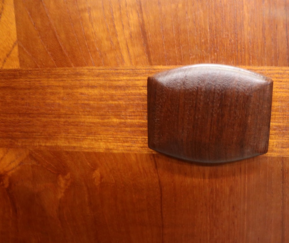 A mid-century teak wood wardrobe featuring two doors with rectangular wooden handles, short tapered legs, and a narrow central full-length mirror. View IV