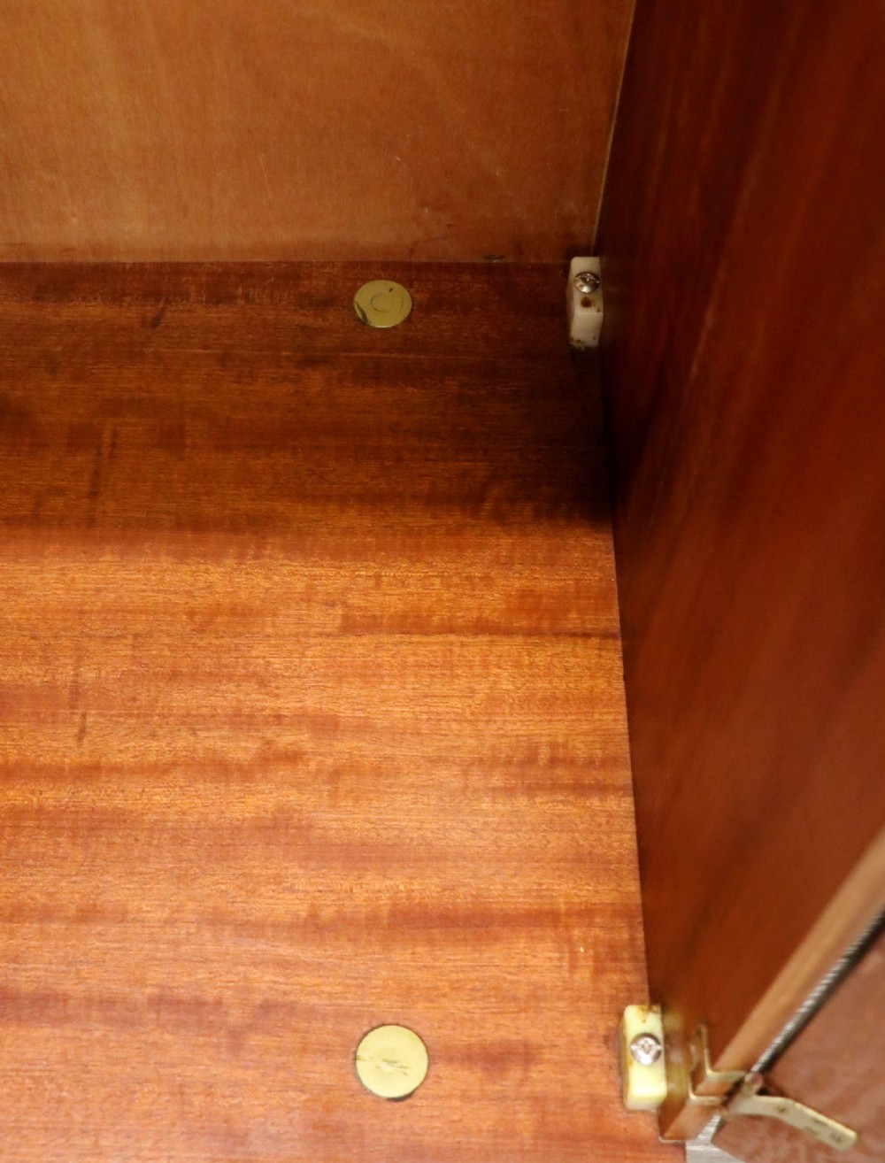 A mid-century teak wood wardrobe featuring two doors with rectangular wooden handles, short tapered legs, and a narrow central full-length mirror. View XII