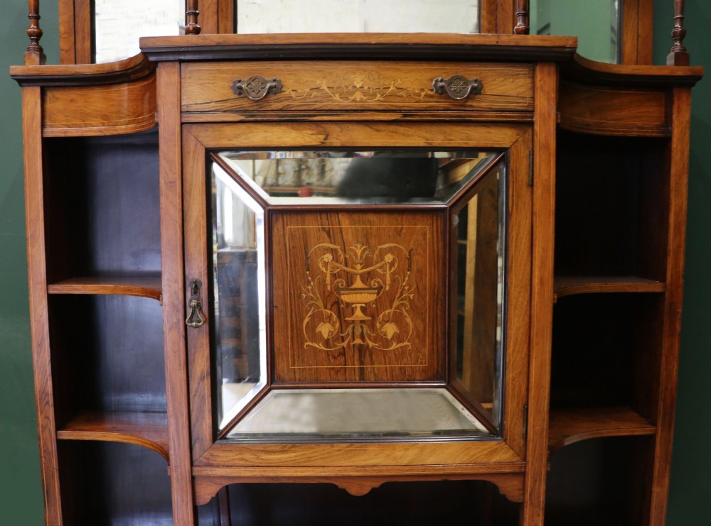 A late Victorian wooden credenza featuring a central inlaid cupboard door, open side shelves, turned spindle pillars, and a multi-pane mirrored back with a fretwork gallery top. View VI