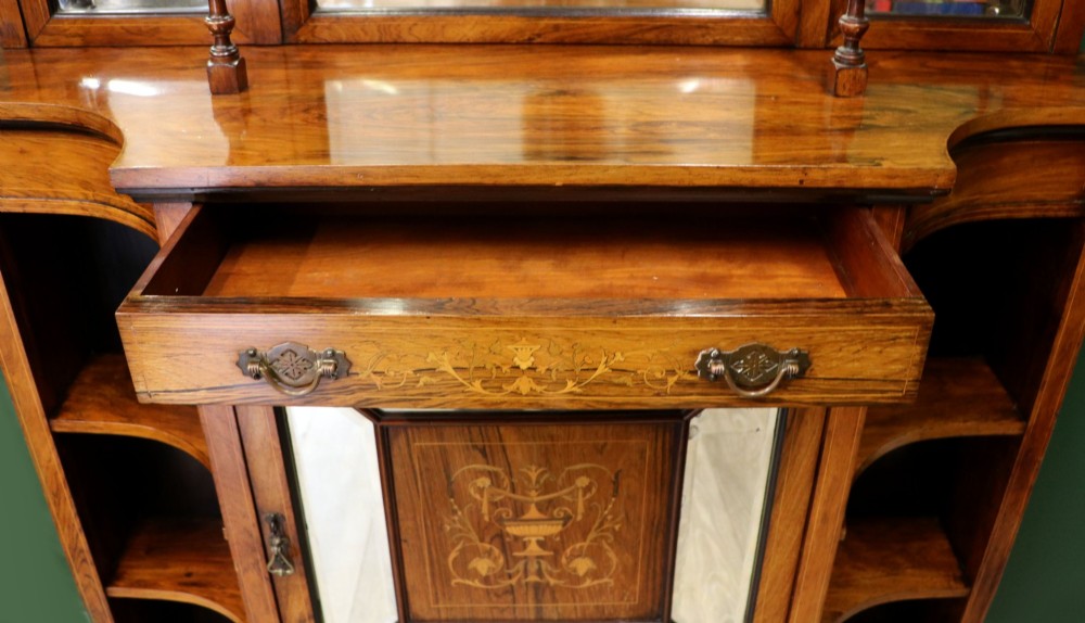 A late Victorian wooden credenza featuring a central inlaid cupboard door, open side shelves, turned spindle pillars, and a multi-pane mirrored back with a fretwork gallery top. View VII