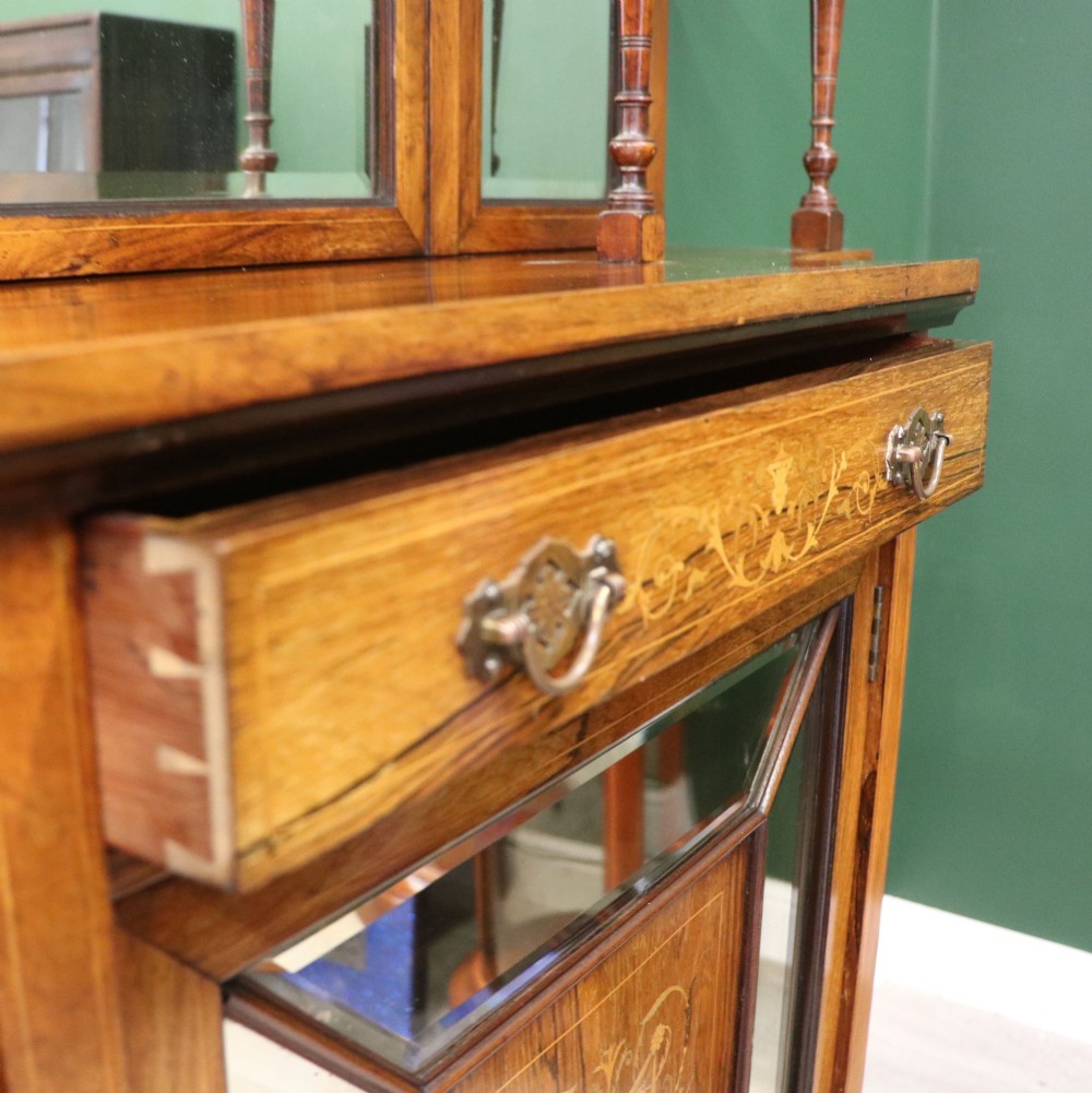 A late Victorian wooden credenza featuring a central inlaid cupboard door, open side shelves, turned spindle pillars, and a multi-pane mirrored back with a fretwork gallery top. View IX