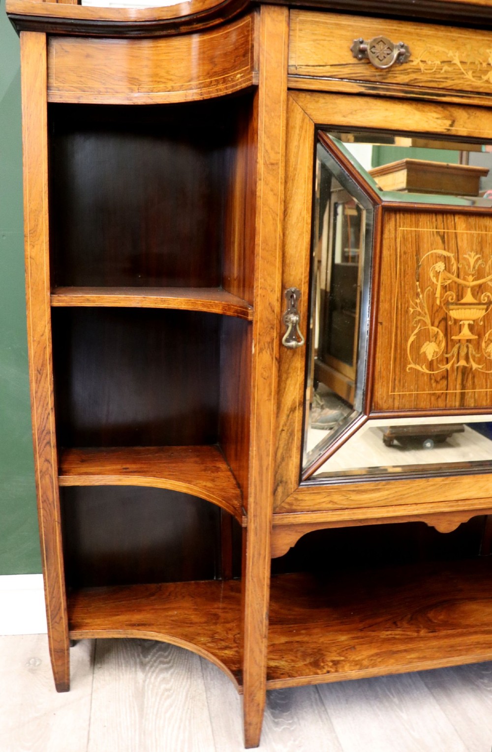 A late Victorian wooden credenza featuring a central inlaid cupboard door, open side shelves, turned spindle pillars, and a multi-pane mirrored back with a fretwork gallery top. View X