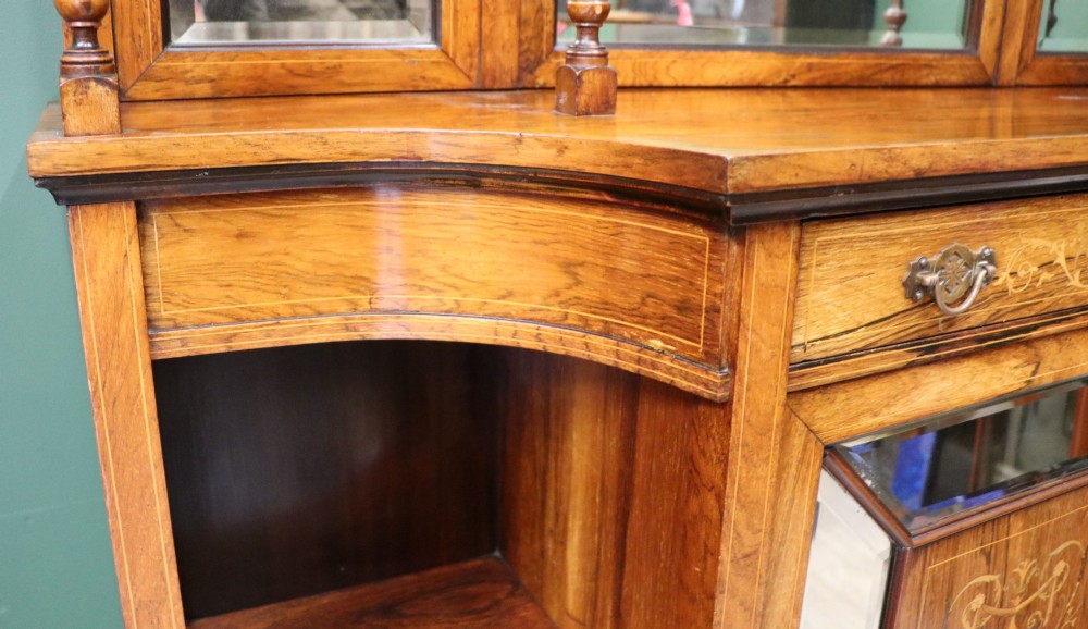 A late Victorian wooden credenza featuring a central inlaid cupboard door, open side shelves, turned spindle pillars, and a multi-pane mirrored back with a fretwork gallery top. View XI