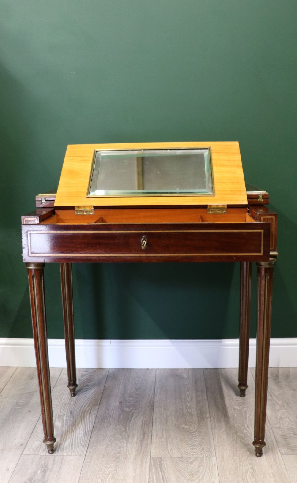 A late nineteenth-century French wooden vanity table featuring an open hinged lid with a mirror, interior satinwood compartments, and slender fluted legs. View II