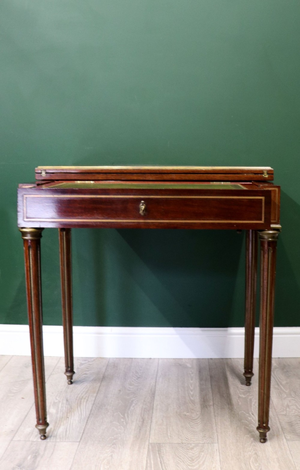 A late nineteenth-century French wooden vanity table featuring an open hinged lid with a mirror, interior satinwood compartments, and slender fluted legs. View IV