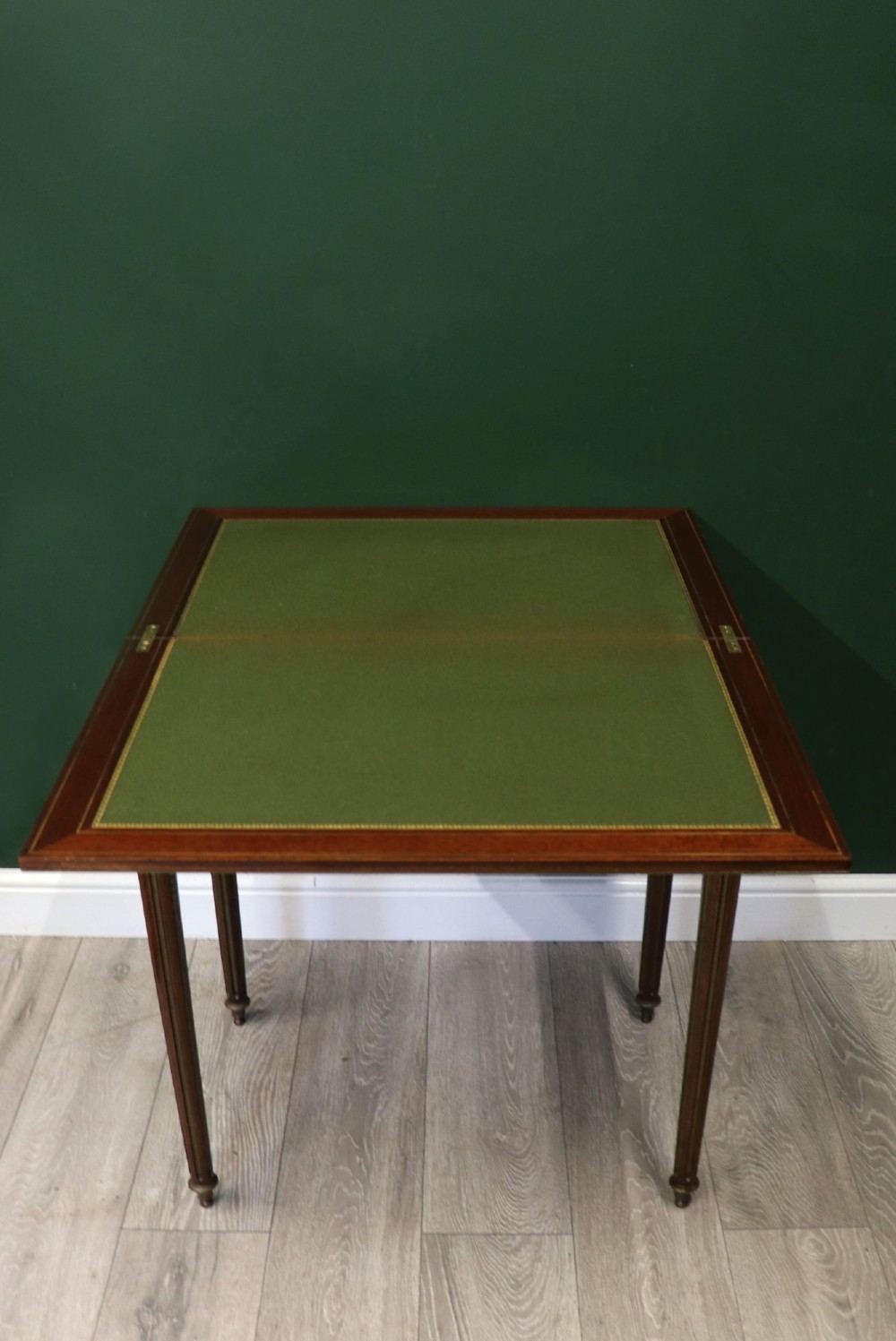A late nineteenth-century French wooden vanity table featuring an open hinged lid with a mirror, interior satinwood compartments, and slender fluted legs. View V