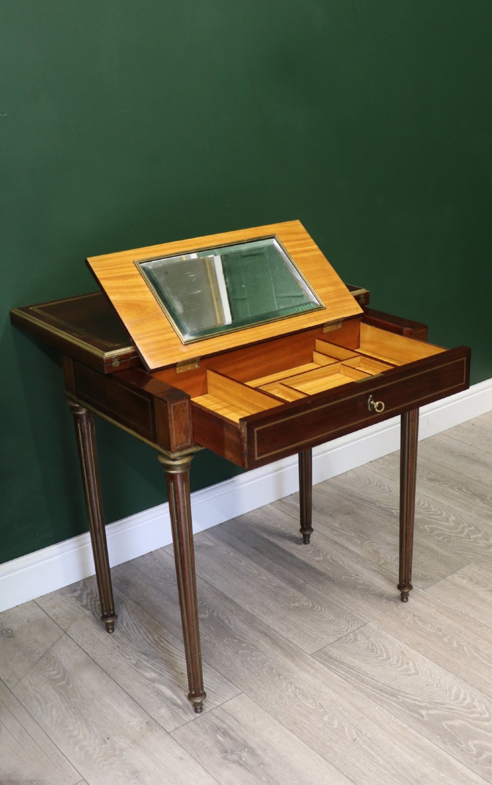 A late nineteenth-century French wooden vanity table featuring an open hinged lid with a mirror, interior satinwood compartments, and slender fluted legs. View VI