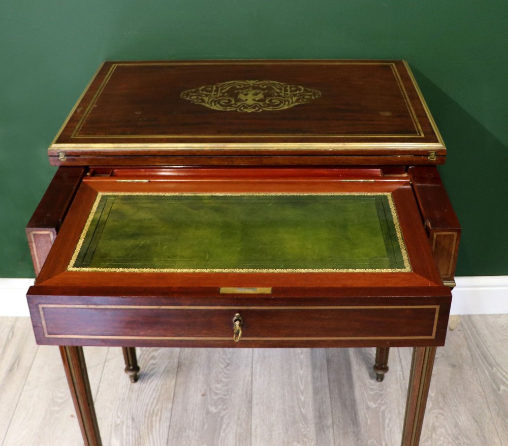 A late nineteenth-century French wooden vanity table featuring an open hinged lid with a mirror, interior satinwood compartments, and slender fluted legs. View VIII