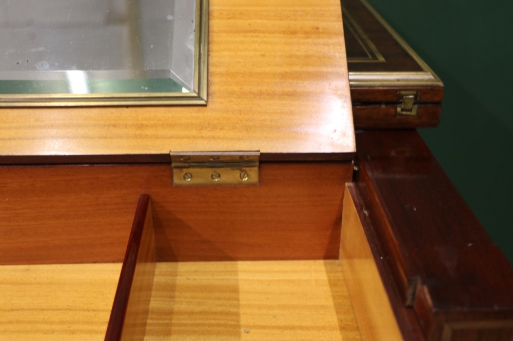 A late nineteenth-century French wooden vanity table featuring an open hinged lid with a mirror, interior satinwood compartments, and slender fluted legs. View XI