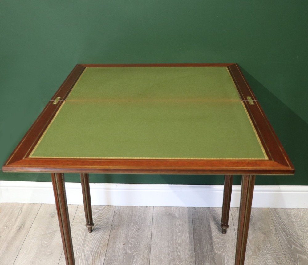 A late nineteenth-century French wooden vanity table featuring an open hinged lid with a mirror, interior satinwood compartments, and slender fluted legs. View XII