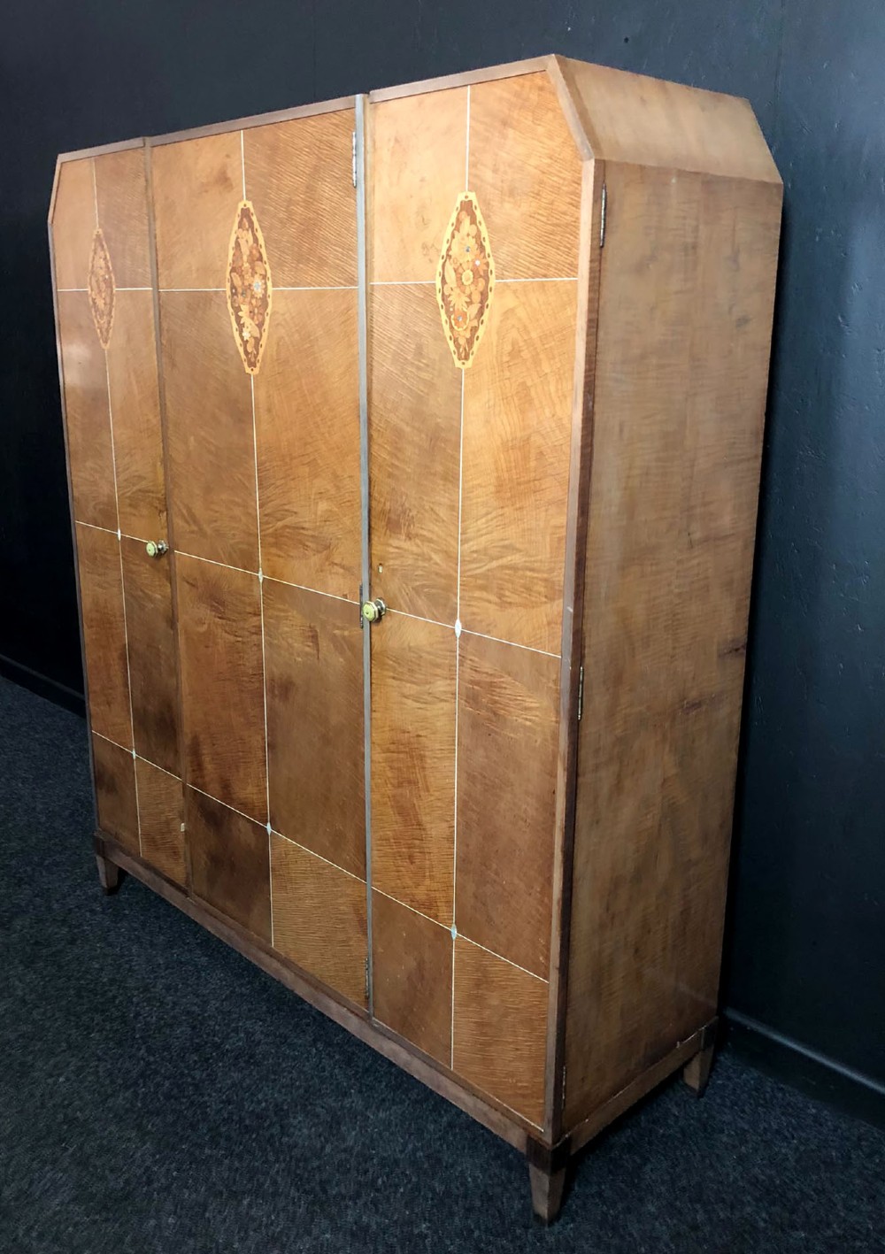 An Art Deco three-door walnut wardrobe featuring geometric panel veneers and oval floral marquetry inlays. View II