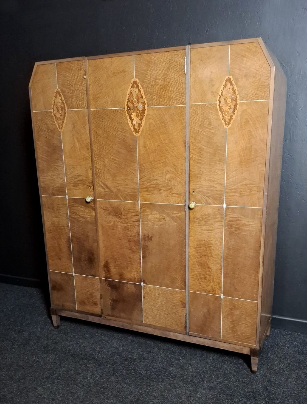 An Art Deco three-door walnut wardrobe featuring geometric panel veneers and oval floral marquetry inlays. View III