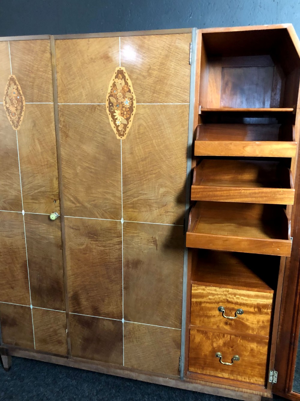 An Art Deco three-door walnut wardrobe featuring geometric panel veneers and oval floral marquetry inlays. View V