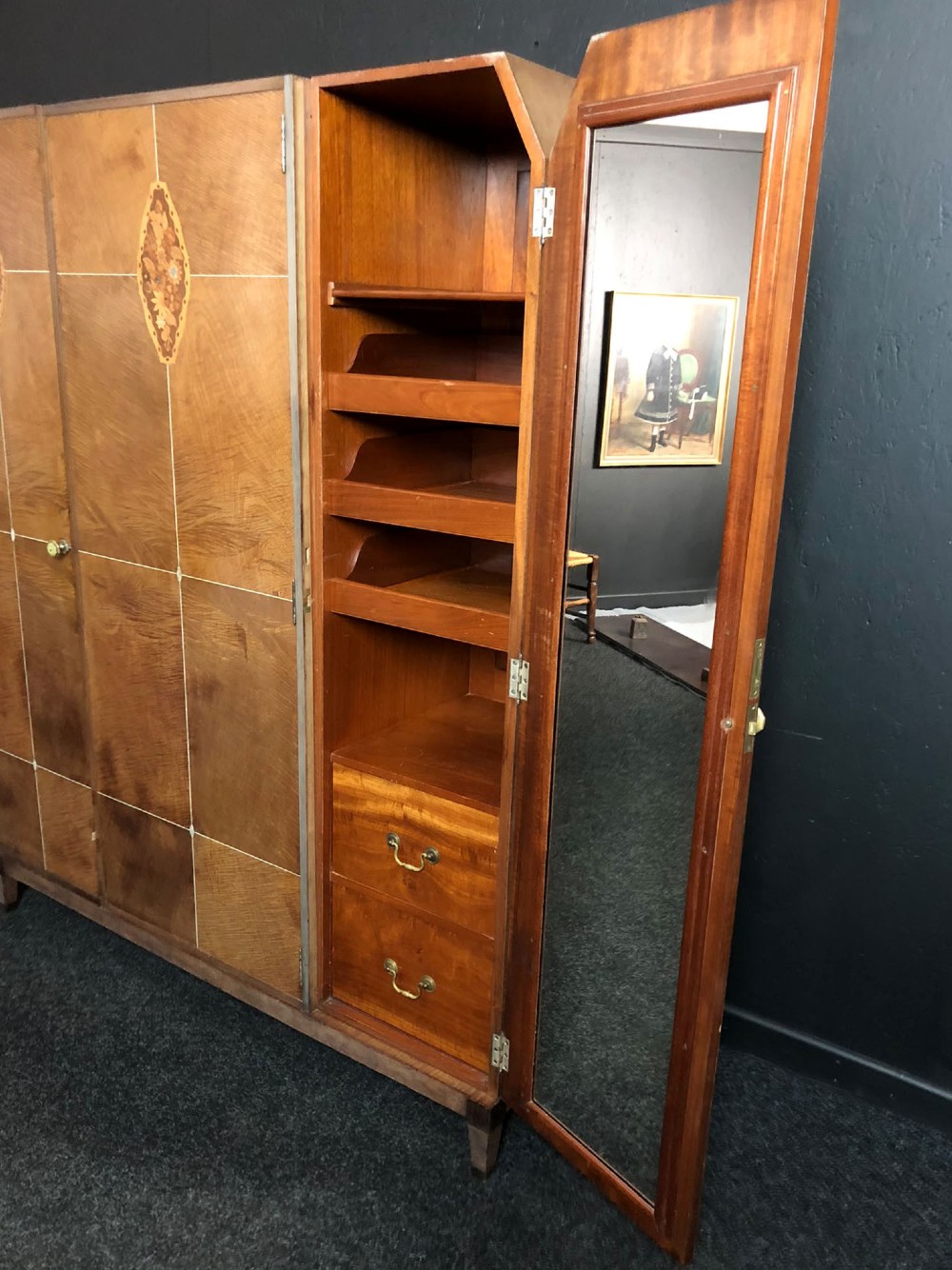 An Art Deco three-door walnut wardrobe featuring geometric panel veneers and oval floral marquetry inlays. View VI