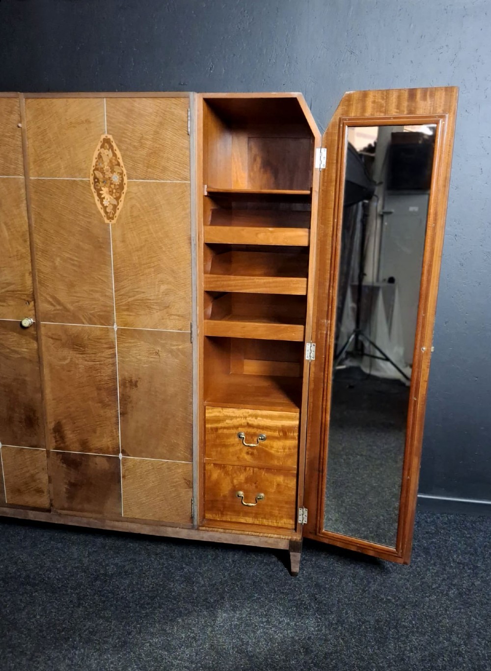 An Art Deco three-door walnut wardrobe featuring geometric panel veneers and oval floral marquetry inlays. View VII