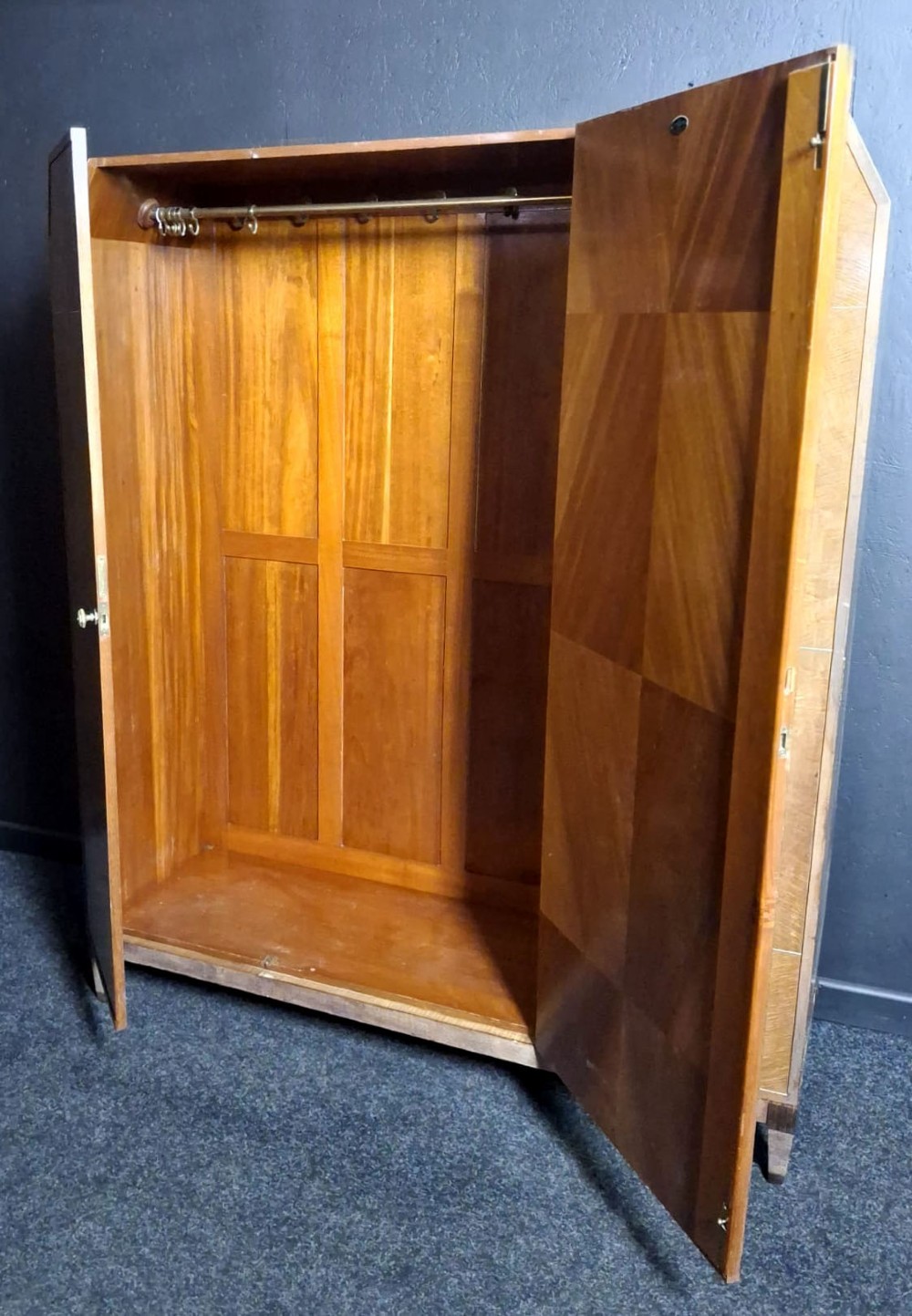 An Art Deco three-door walnut wardrobe featuring geometric panel veneers and oval floral marquetry inlays. View VIII