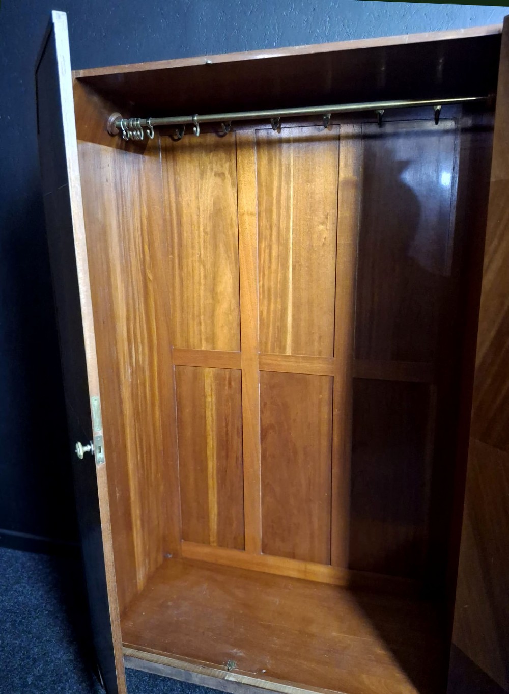 An Art Deco three-door walnut wardrobe featuring geometric panel veneers and oval floral marquetry inlays. View IX