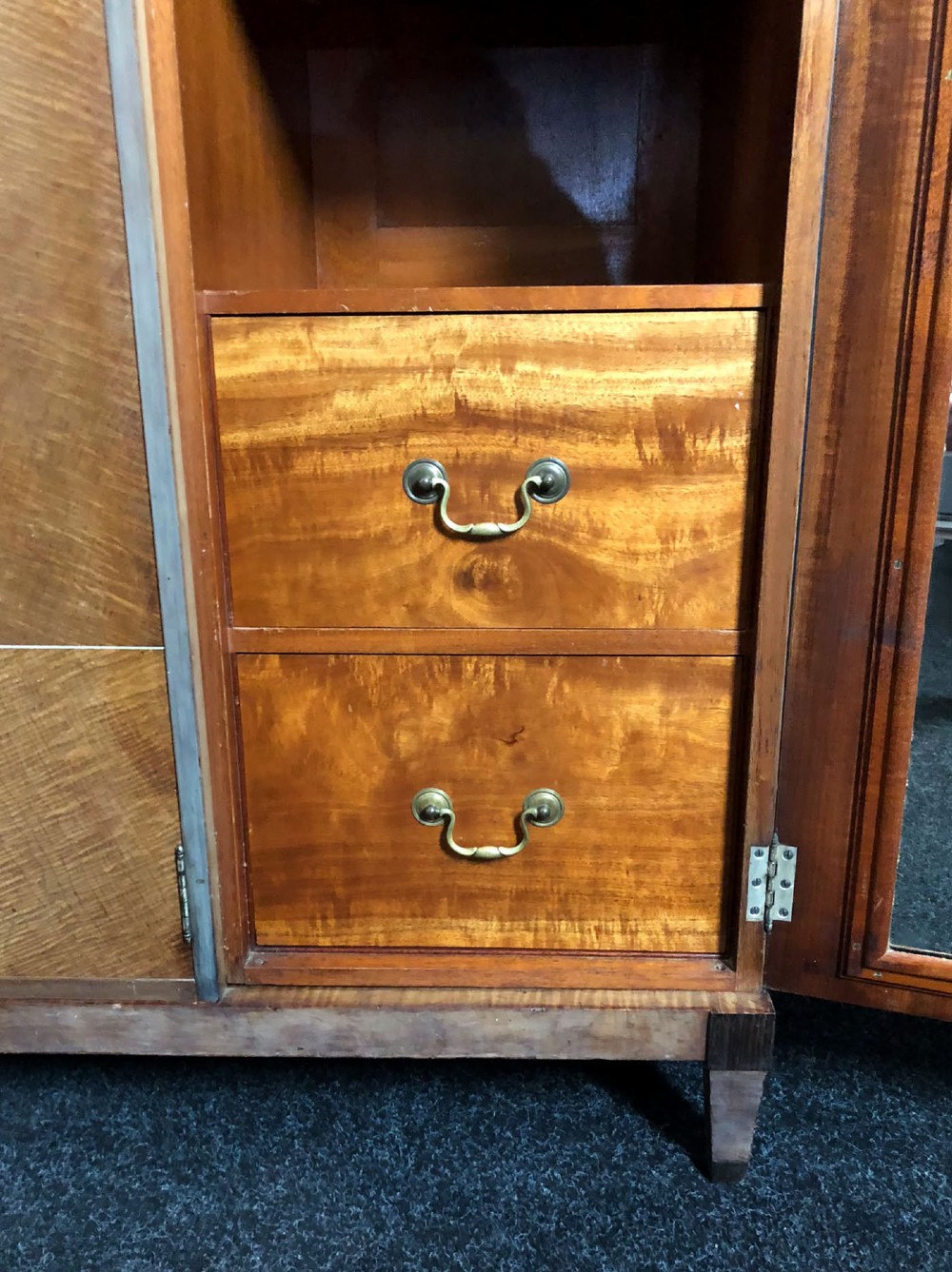 An Art Deco three-door walnut wardrobe featuring geometric panel veneers and oval floral marquetry inlays. View X