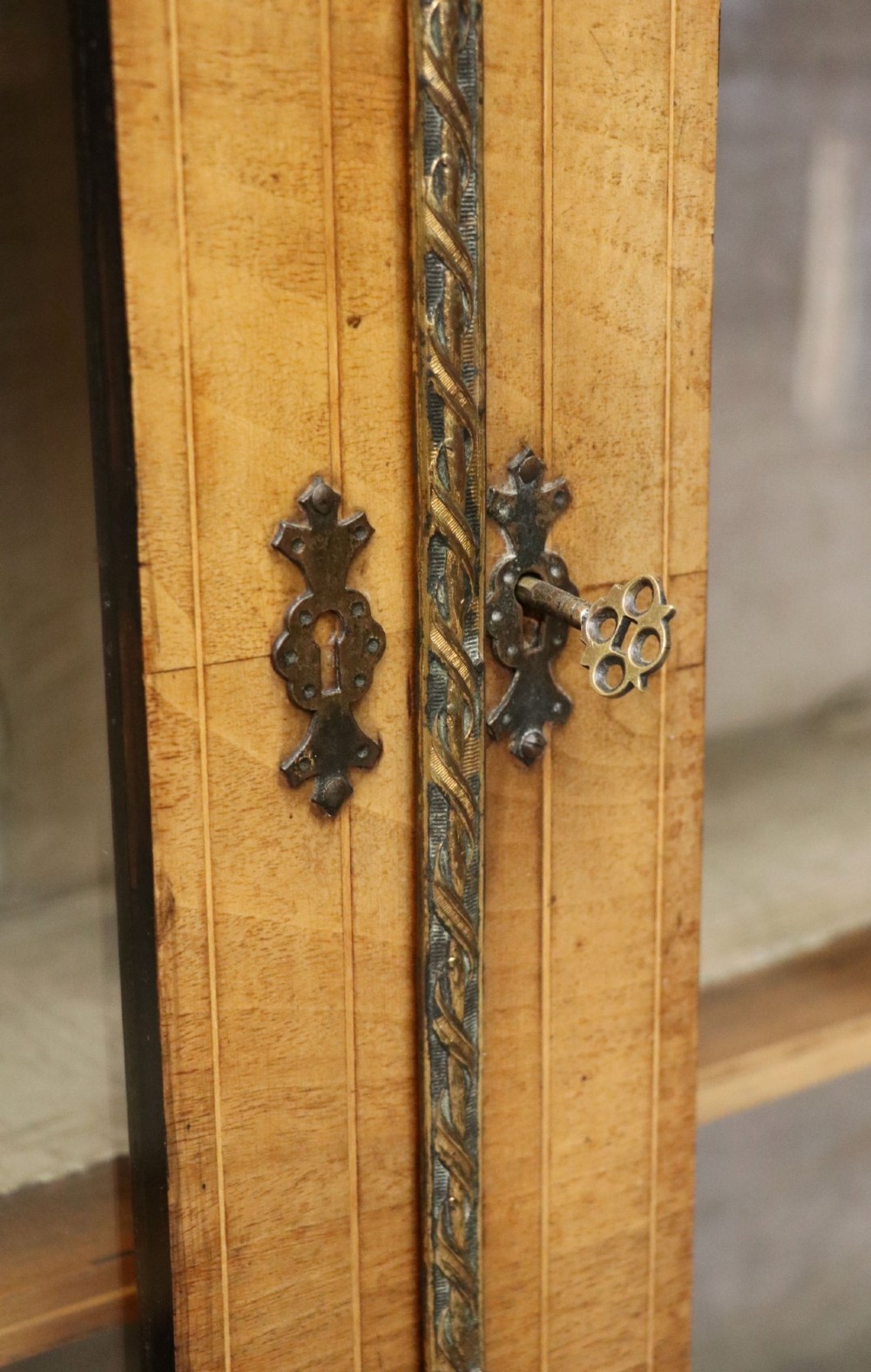 A mid-Victorian low walnut veneered bookcase featuring two glass glazed doors, marquetry inlay along the frieze, and brass trim detailing. View IX