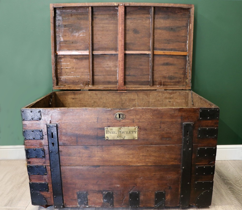 A 19th-century dark oak storage chest reinforced with black iron strapping and featuring a central brass plaque. View II