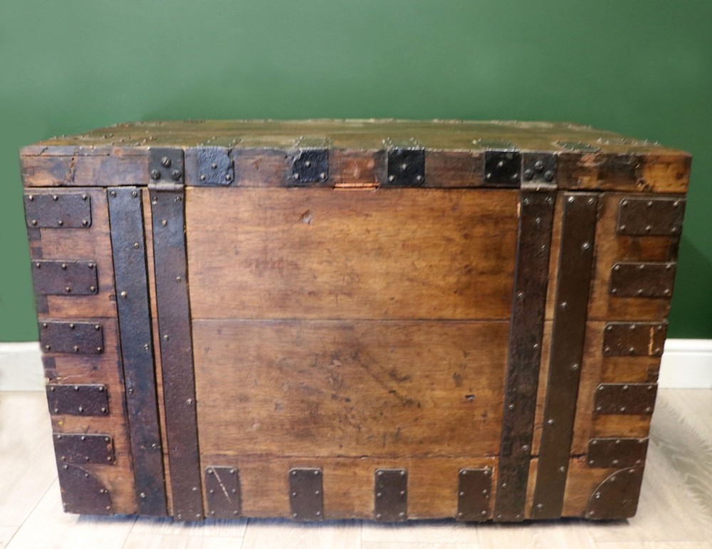 A 19th-century dark oak storage chest reinforced with black iron strapping and featuring a central brass plaque. View IV