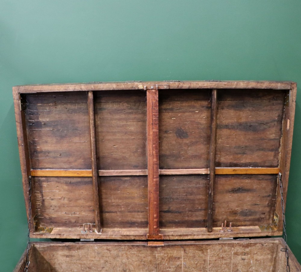 A 19th-century dark oak storage chest reinforced with black iron strapping and featuring a central brass plaque. View XIII