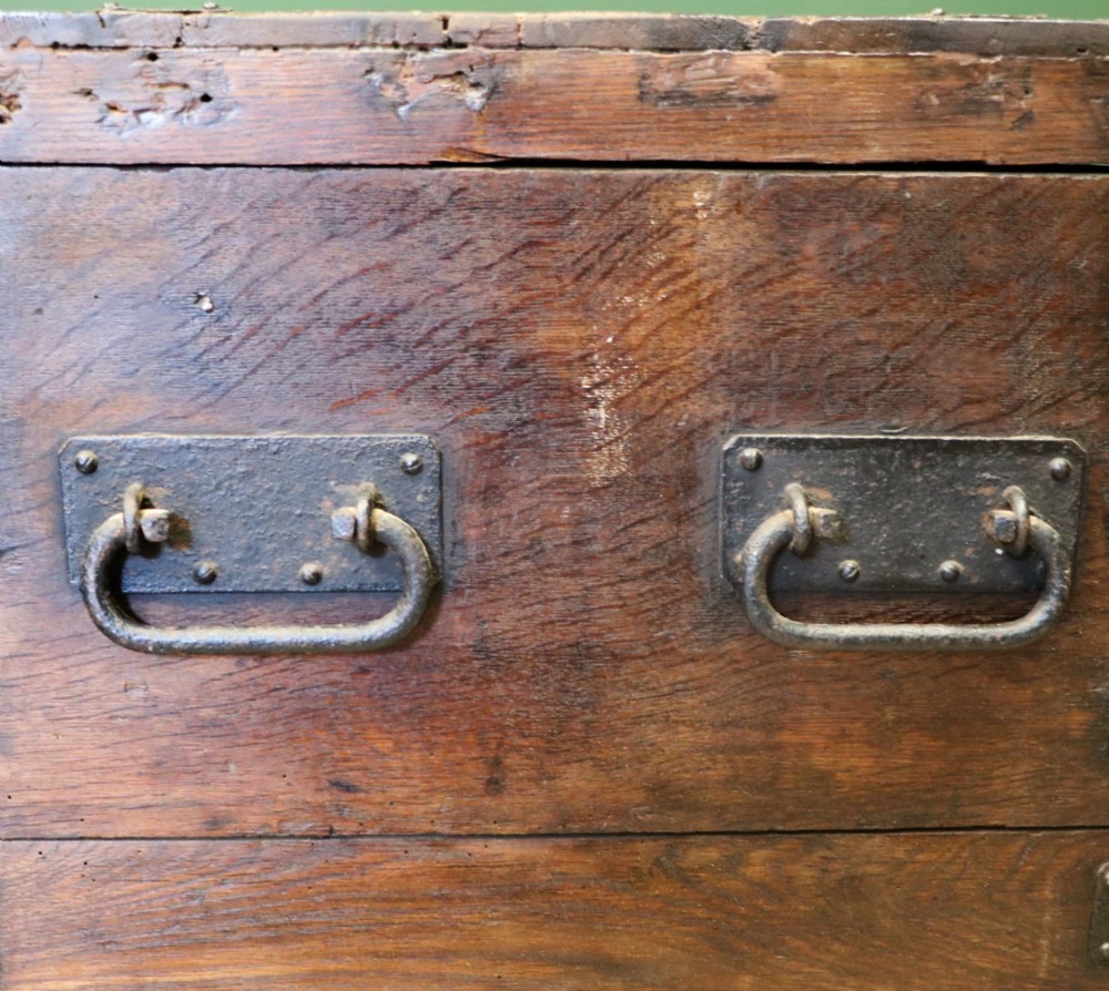 A 19th-century dark oak storage chest reinforced with black iron strapping and featuring a central brass plaque. View XIV