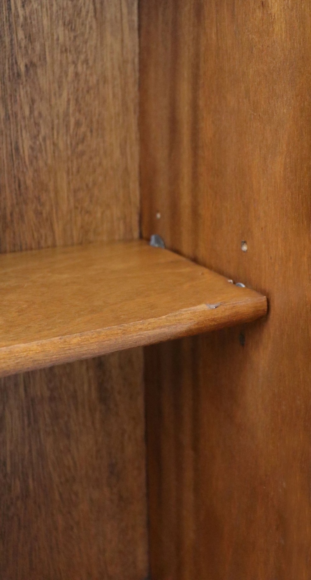 A low mid-century teak bookcase with two sliding glass doors featuring printed lettering alongside a single solid teak cupboard door. View XI