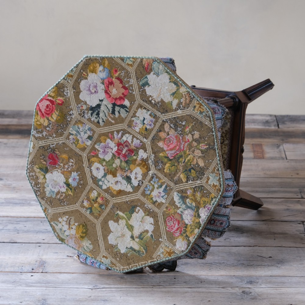 A 19th-century octagonal Aesthetic Movement side table with turned ebonised legs, a lower shelf, and a beaded tapestry top. View IV