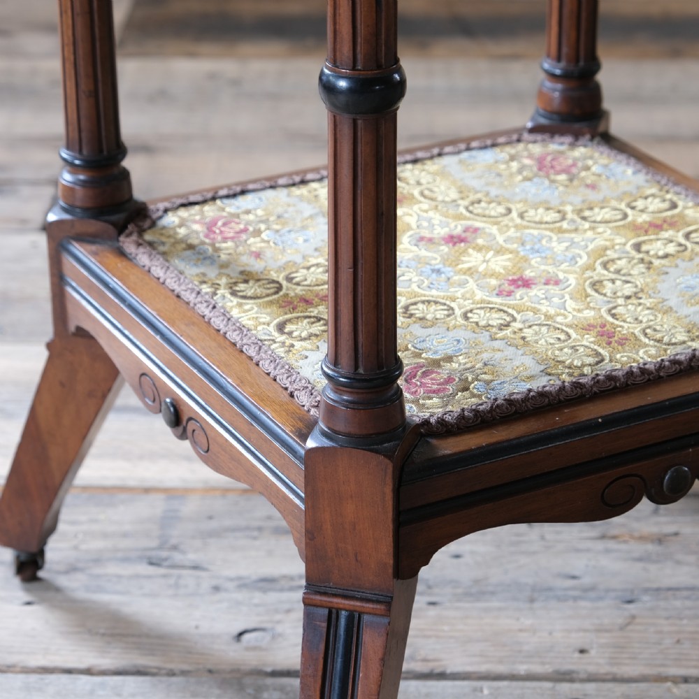 A 19th-century octagonal Aesthetic Movement side table with turned ebonised legs, a lower shelf, and a beaded tapestry top. View VIII