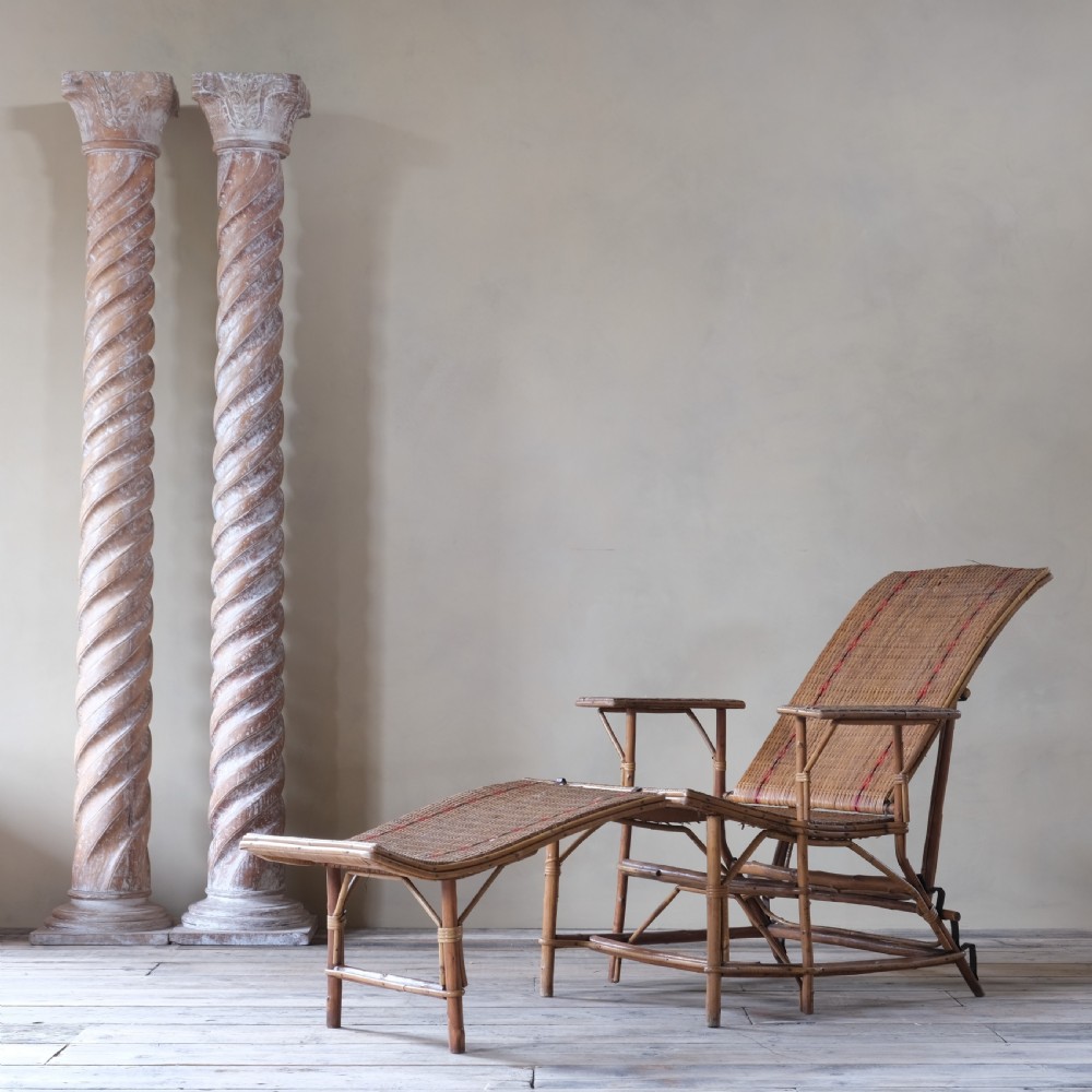 An antique French bamboo reclining chaise longue with a woven cane seat, raised armrests, and extending footrest. View II