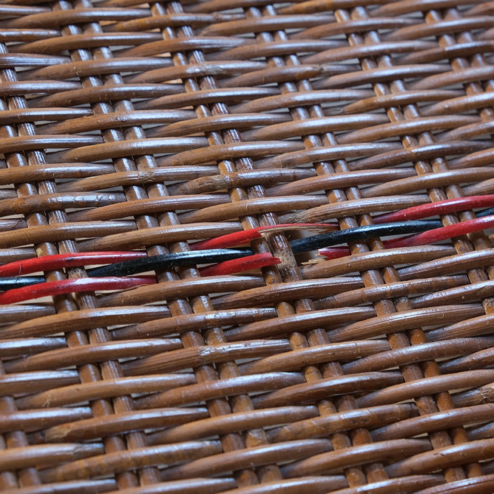 An antique French bamboo reclining chaise longue with a woven cane seat, raised armrests, and extending footrest. View IX