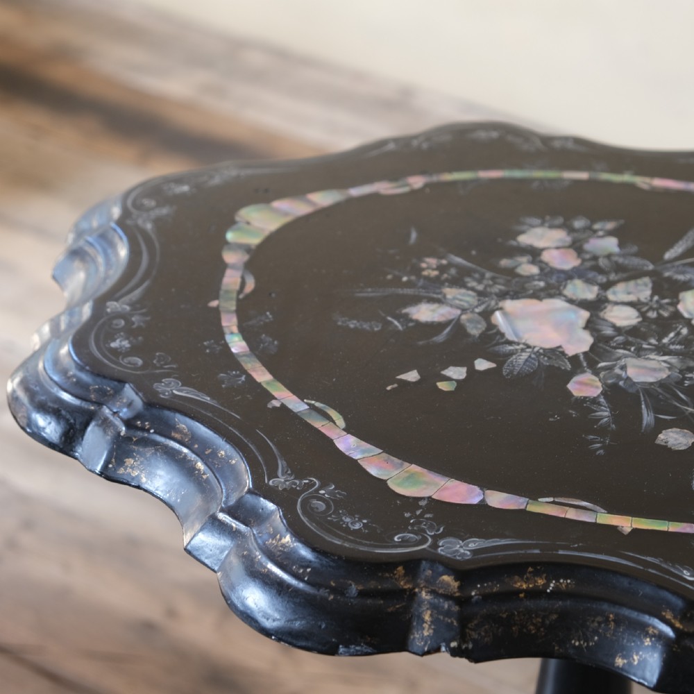 A 19th-century black lacquer papier-mache side table featuring a scalloped floral inlaid top on a turned pedestal with scroll feet. View II