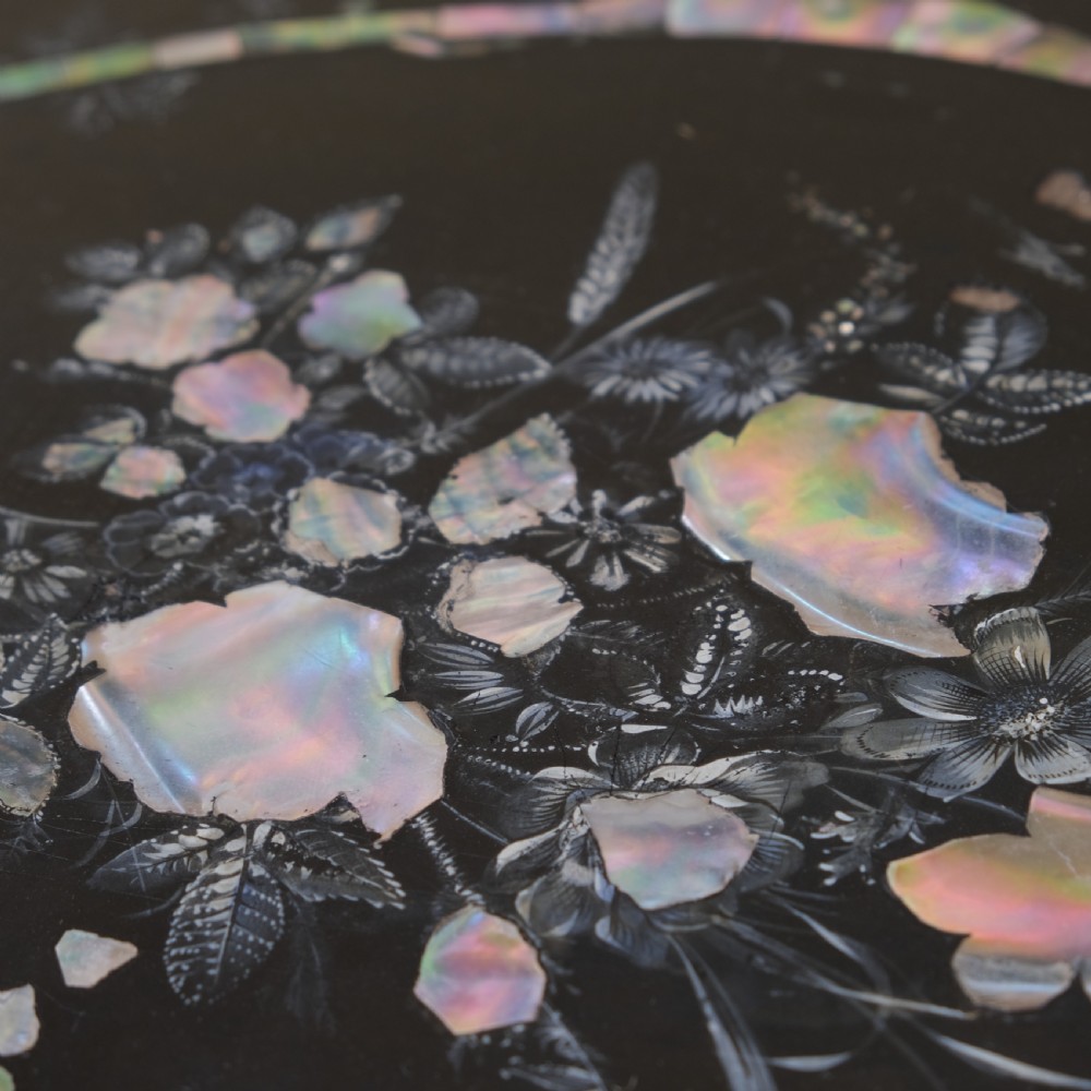 A 19th-century black lacquer papier-mache side table featuring a scalloped floral inlaid top on a turned pedestal with scroll feet. View V
