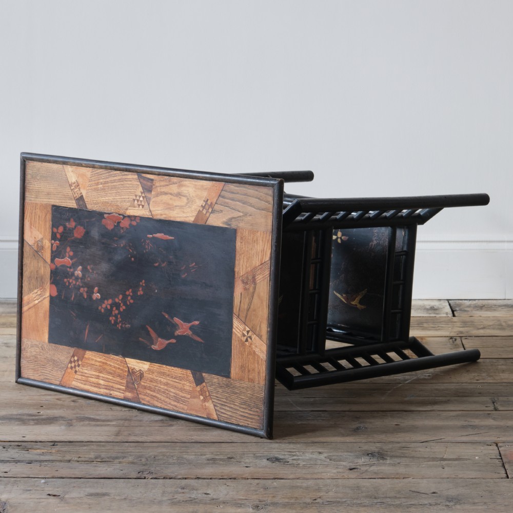 A Victorian Anglo-Japanese ebonised black lacquered three-tier side table featuring lattice side panels and spindled shelf galleries. View VIII