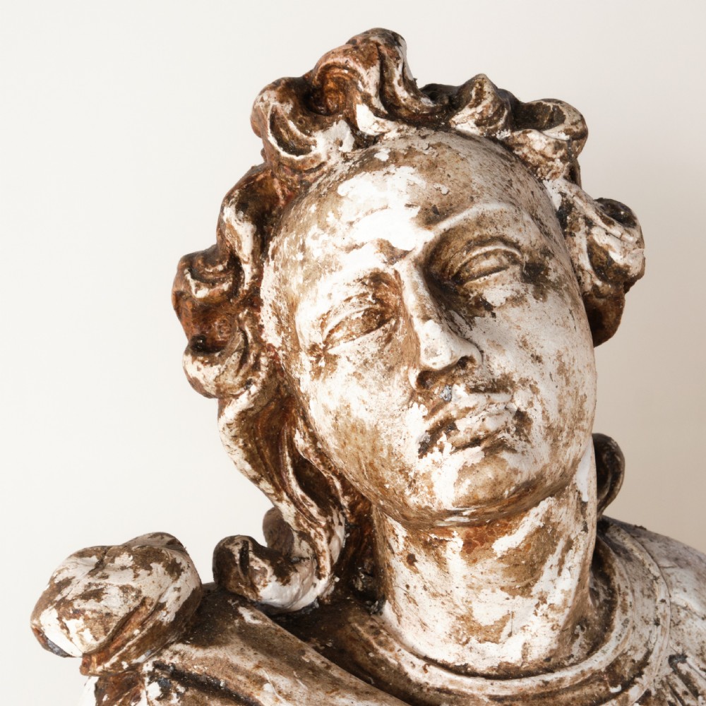 A large freestanding ecclesiastical plaster statue of a saint wearing draped robes, resting on a square pedestal with a distressed brown patinated surface. View VIII