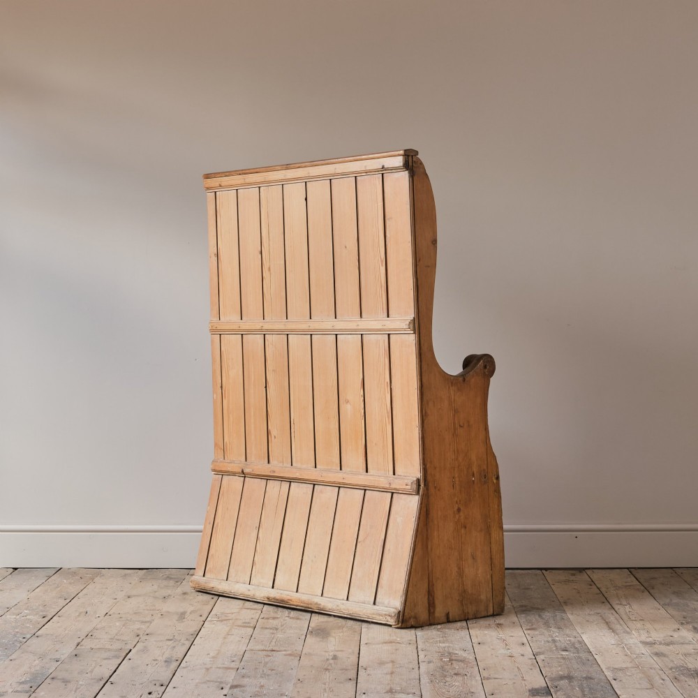A 19th-century pine and elm high-backed settle featuring scrolled armrests and vertical plank construction. View VIII