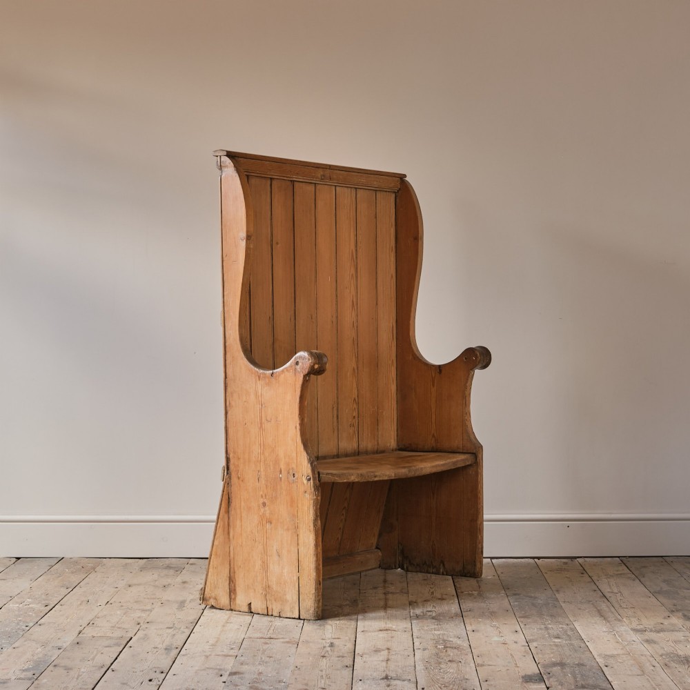 A 19th-century pine and elm high-backed settle featuring scrolled armrests and vertical plank construction. View IX