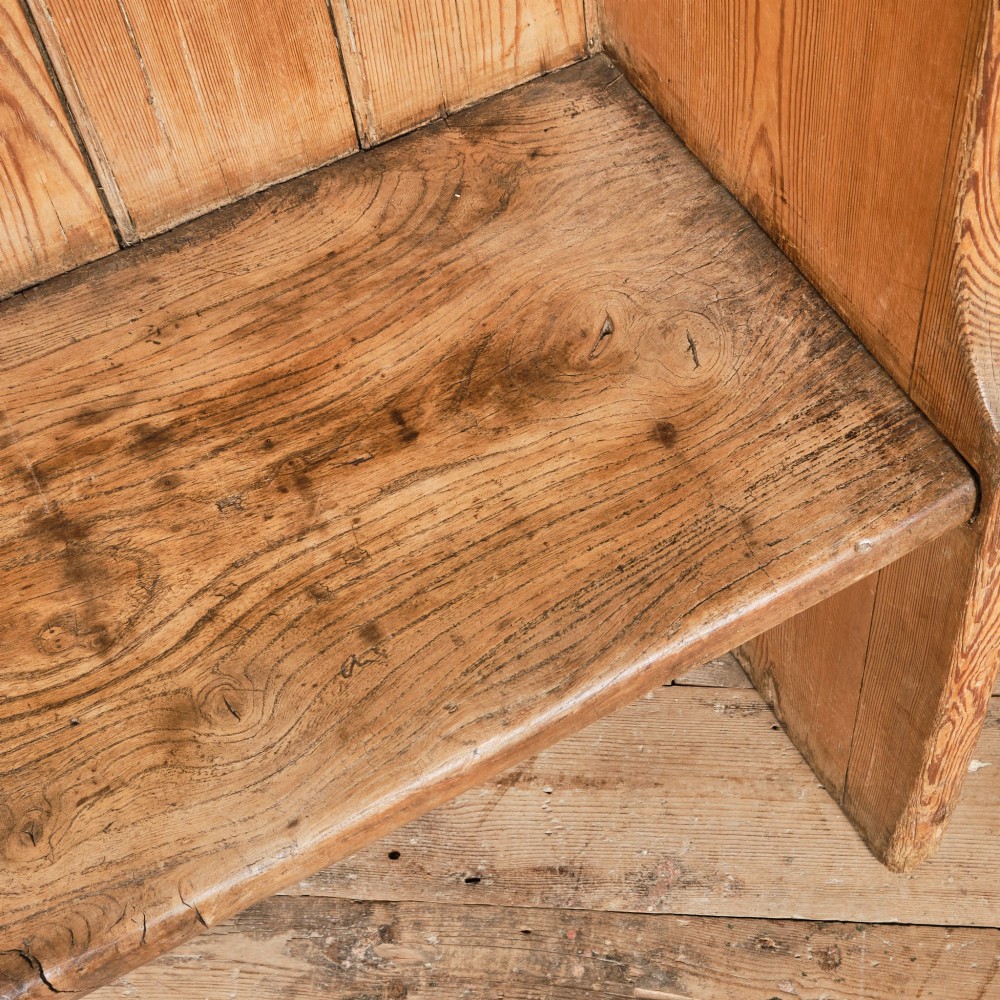 A 19th-century pine and elm high-backed settle featuring scrolled armrests and vertical plank construction. View XIII