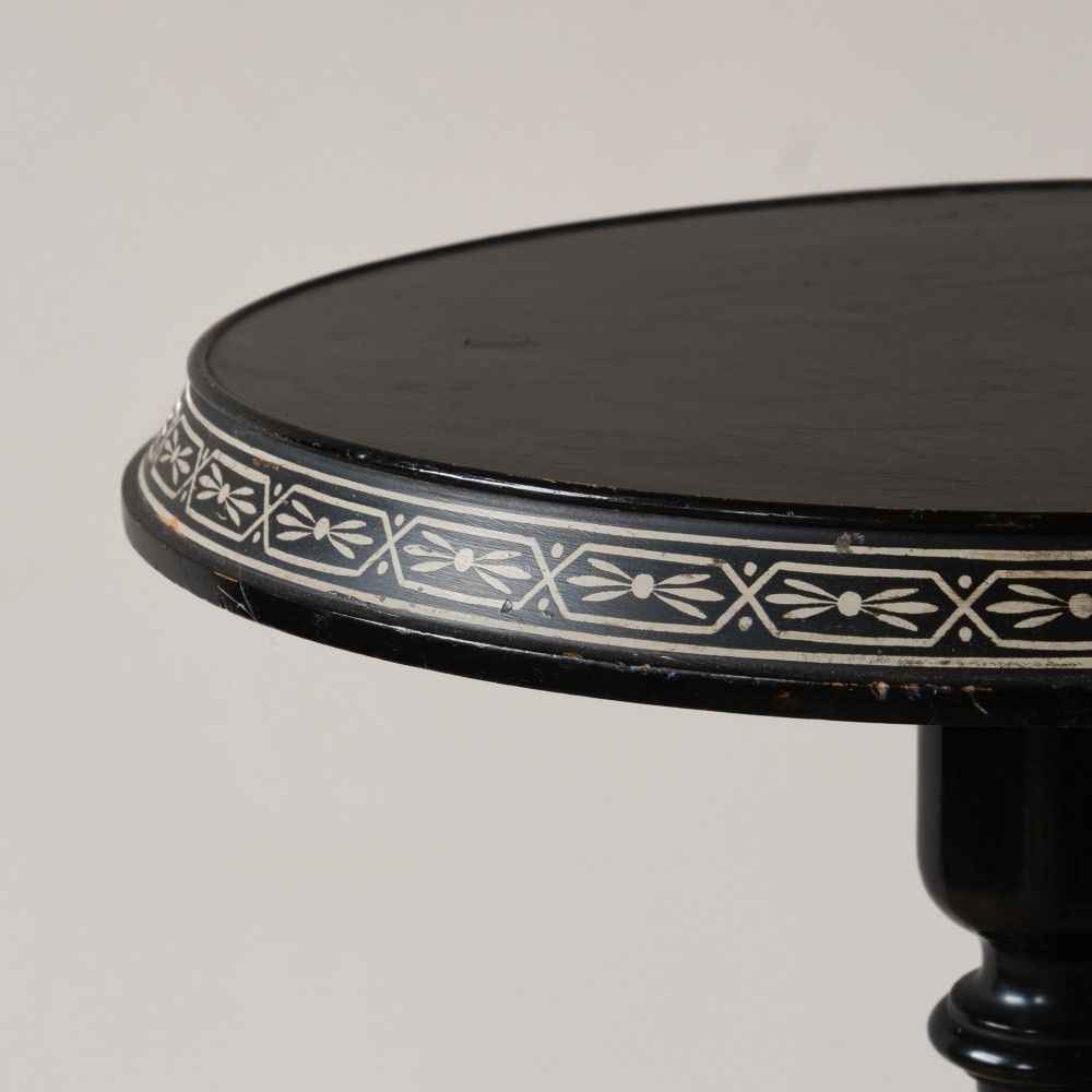 A 19th-century Aesthetic Movement ebonised tripod side table featuring a circular top, turned central column, light-coloured decorative inlay, and finial details. View II
