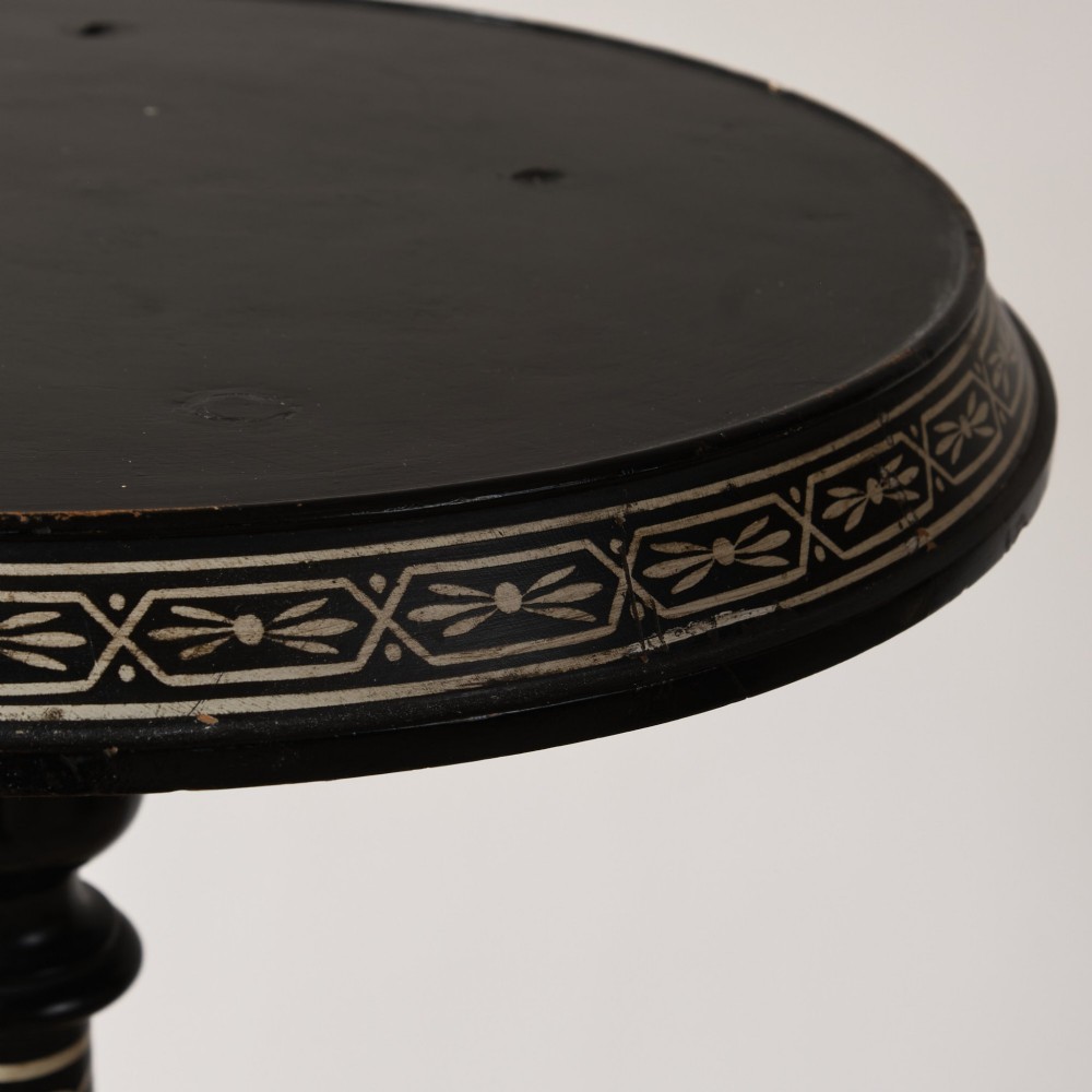 A 19th-century Aesthetic Movement ebonised tripod side table featuring a circular top, turned central column, light-coloured decorative inlay, and finial details. View III