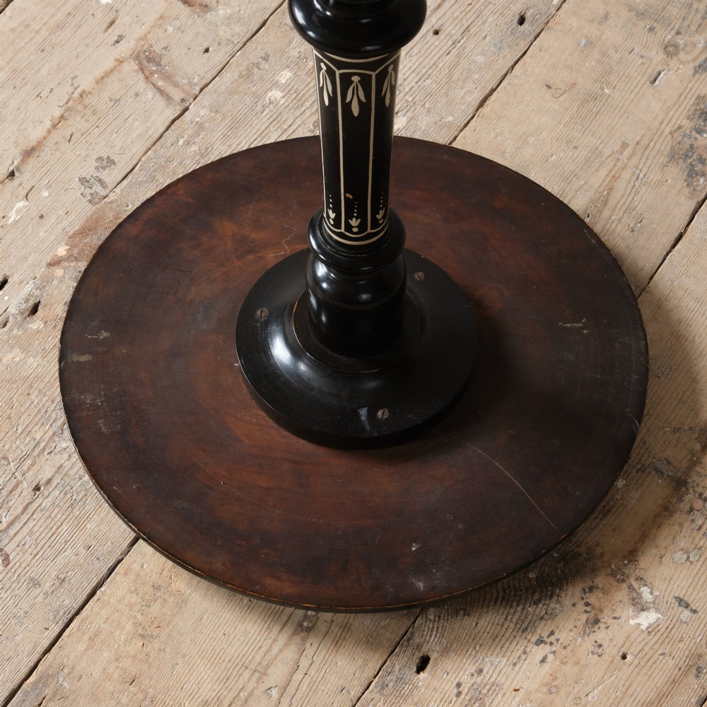 A 19th-century Aesthetic Movement ebonised tripod side table featuring a circular top, turned central column, light-coloured decorative inlay, and finial details. View VII