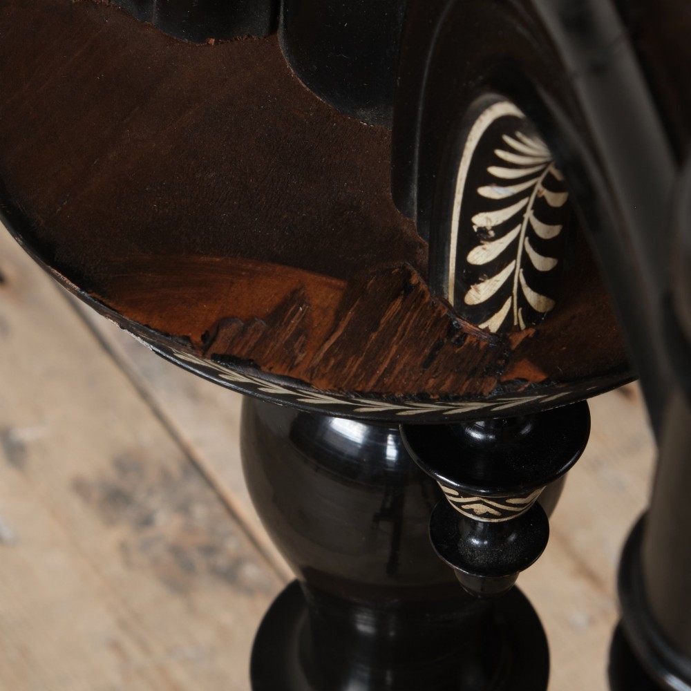 A 19th-century Aesthetic Movement ebonised tripod side table featuring a circular top, turned central column, light-coloured decorative inlay, and finial details. View VIII
