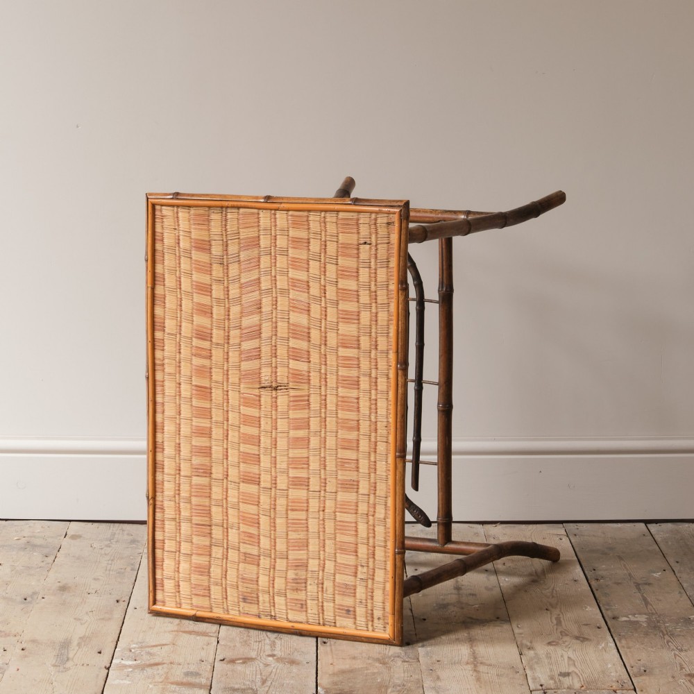 An early 20th-century bamboo side table featuring a rectangular woven cane top, bamboo legs, and lower cross stretchers. View IV