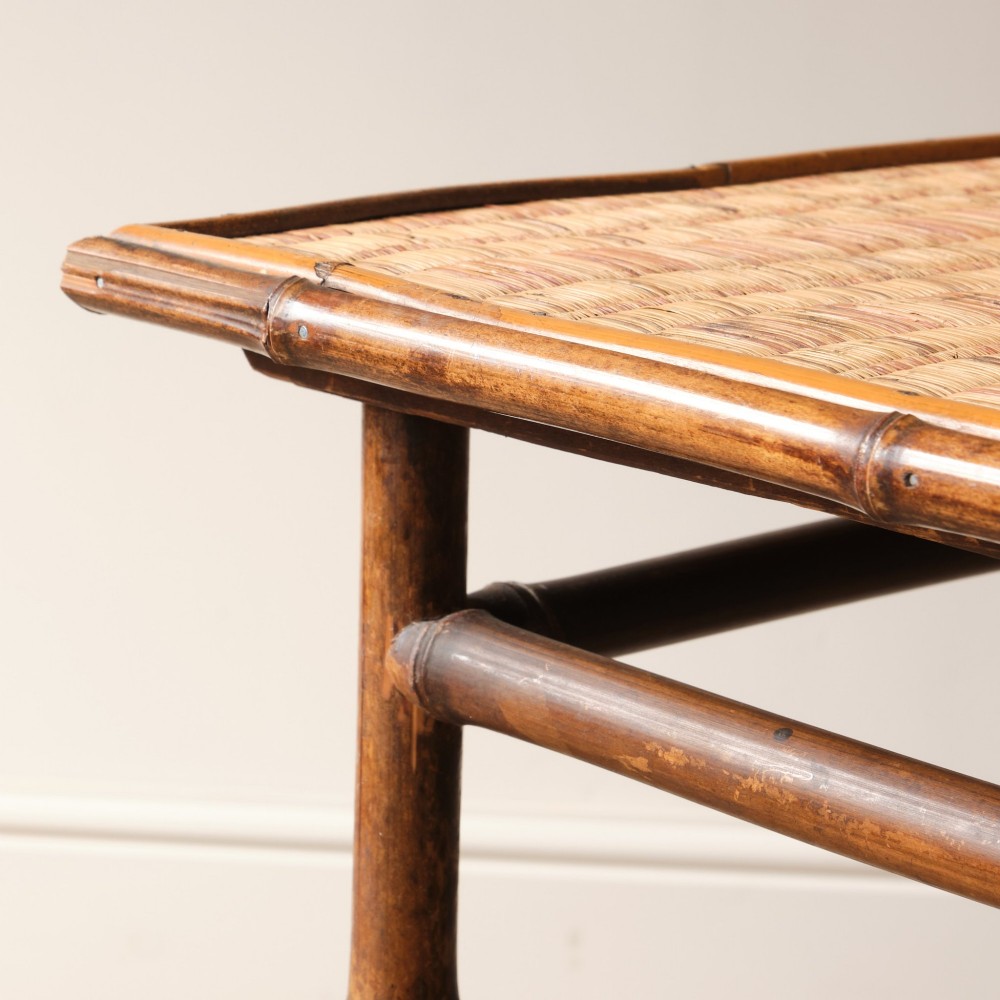 An early 20th-century bamboo side table featuring a rectangular woven cane top, bamboo legs, and lower cross stretchers. View VII