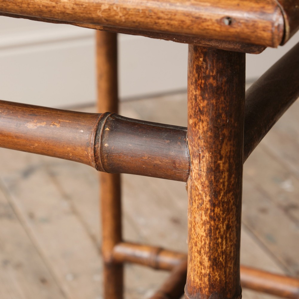 An early 20th-century bamboo side table featuring a rectangular woven cane top, bamboo legs, and lower cross stretchers. View VIII