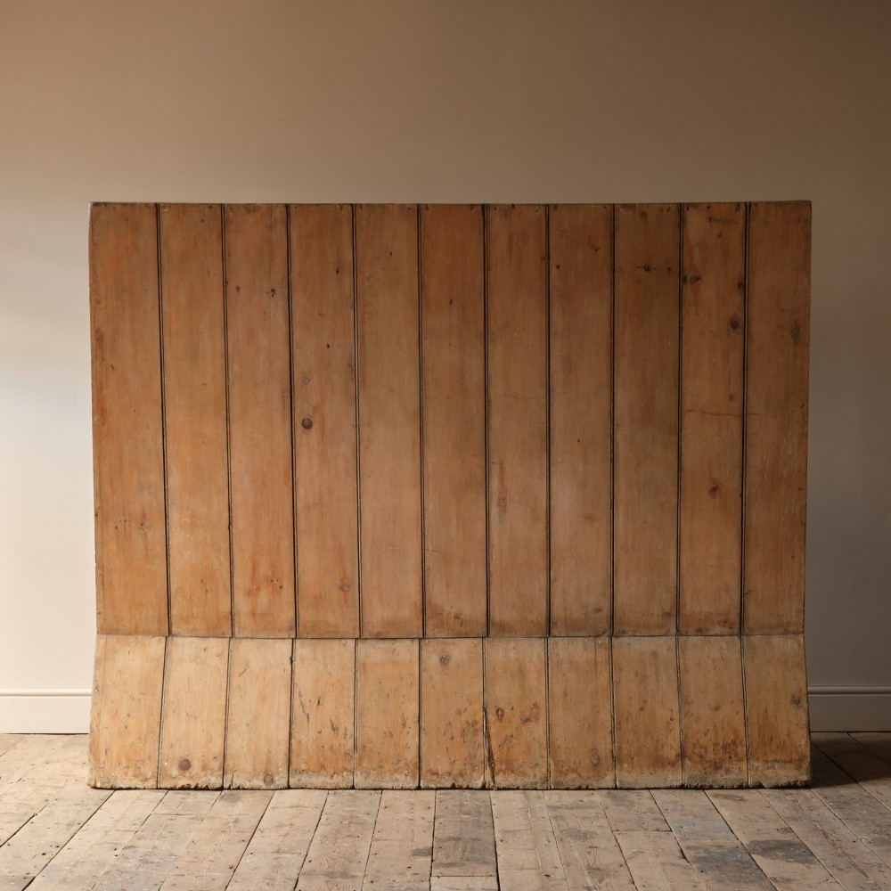 An early nineteenth-century Georgian pine high-backed settle featuring winged side panels and a planked box base. View VIII