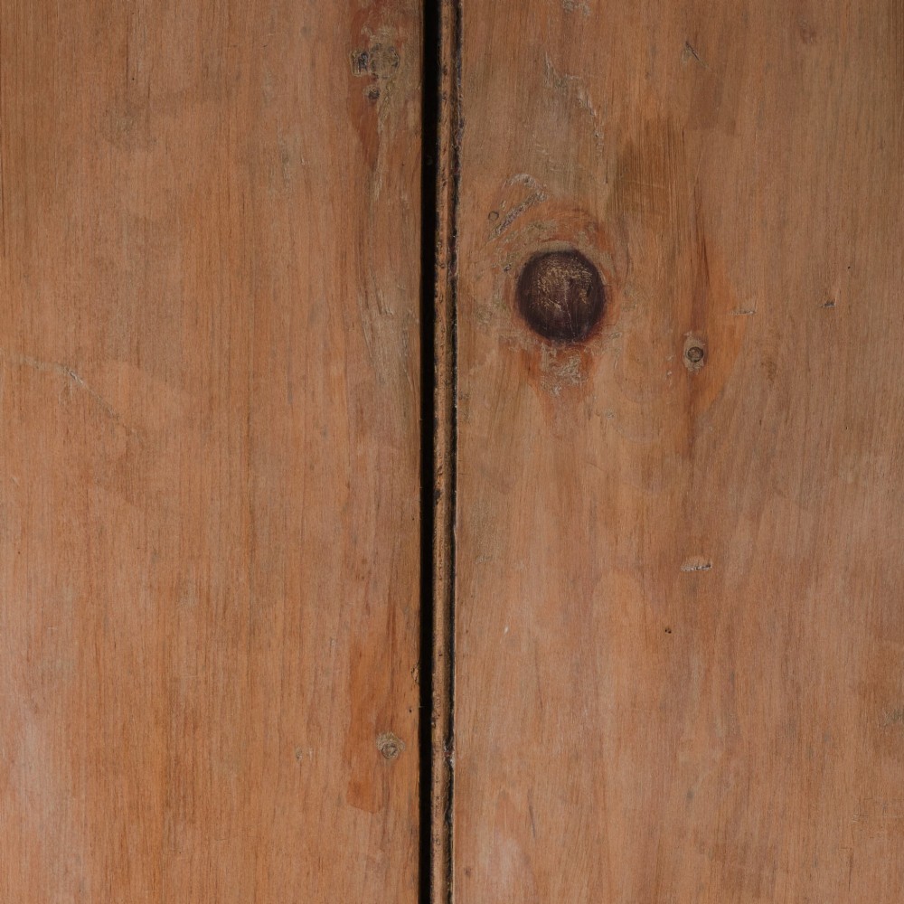 An early nineteenth-century Georgian pine high-backed settle featuring winged side panels and a planked box base. View XII